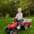 Case ih lil tractor  trailer boy outdoors l facing